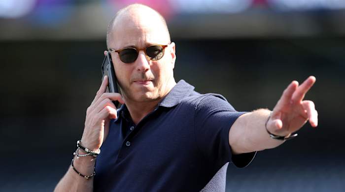 Oct 2, 2019; New York, NY, USA; New York Yankees general manger Brian Cashman gestures while on the phone during a workout day before game 1 of the ALDS at Yankees Stadium.